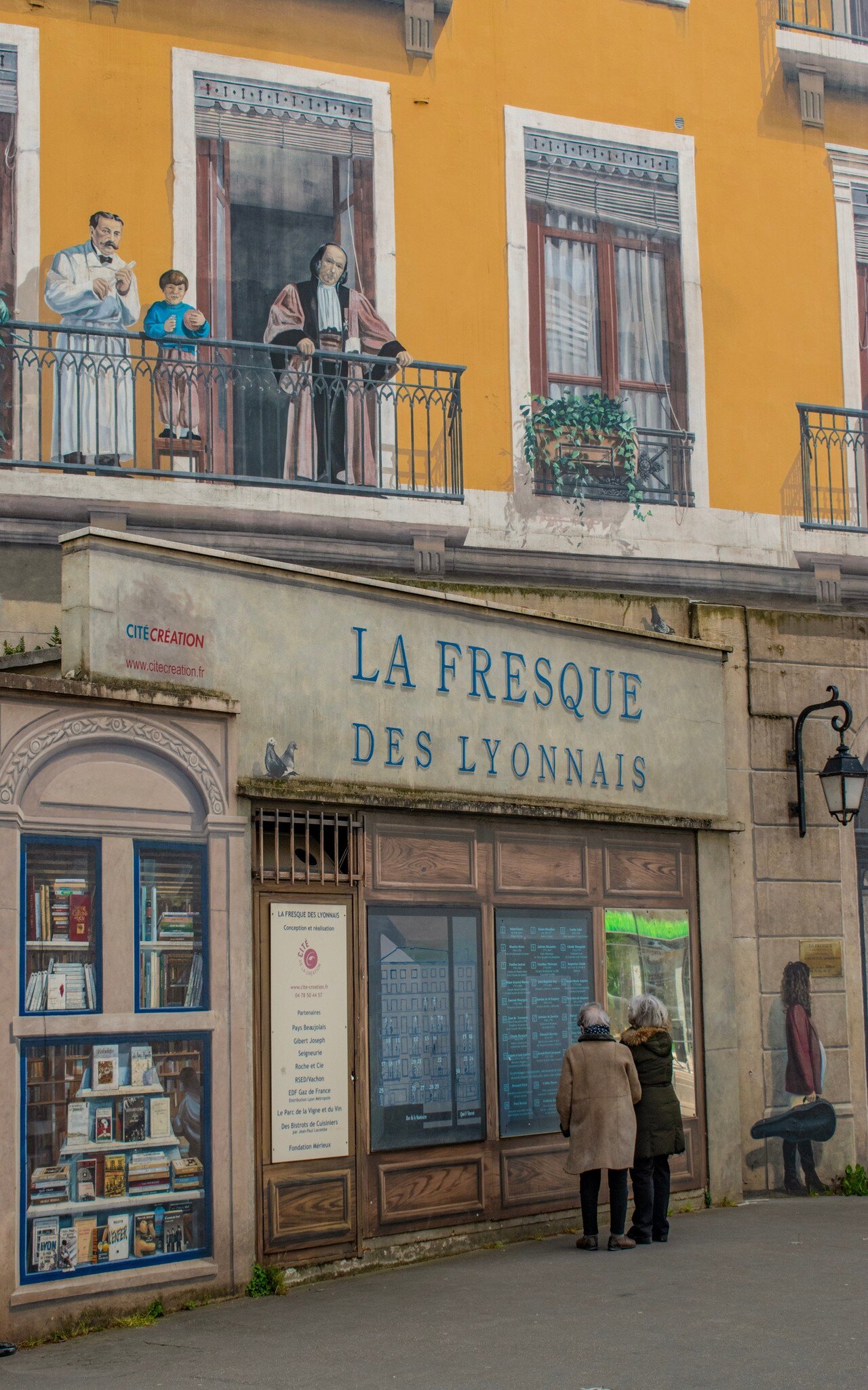 Lyon, France, 04-23-2024: people looking at Fresque des Lyonnais (Fresco of the Lyonnais), mural by the artistic collective Cite de la Creation celebrating the most influential historic city figures, License Type: media, Download Time: 2026-06-24T17:47:37.000Z, User: LP_ZRay, Editorial: true, purchase_order: 65050 - Digital Destinations and Articles, job: Lonely Planet, client: App Content, other: Zayira Ray
