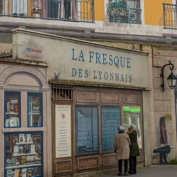 Lyon, France, 04-23-2024: people looking at Fresque des Lyonnais (Fresco of the Lyonnais), mural by the artistic collective Cite de la Creation celebrating the most influential historic city figures, License Type: media, Download Time: 2026-06-24T17:47:37.000Z, User: LP_ZRay, Editorial: true, purchase_order: 65050 - Digital Destinations and Articles, job: Lonely Planet, client: App Content, other: Zayira Ray