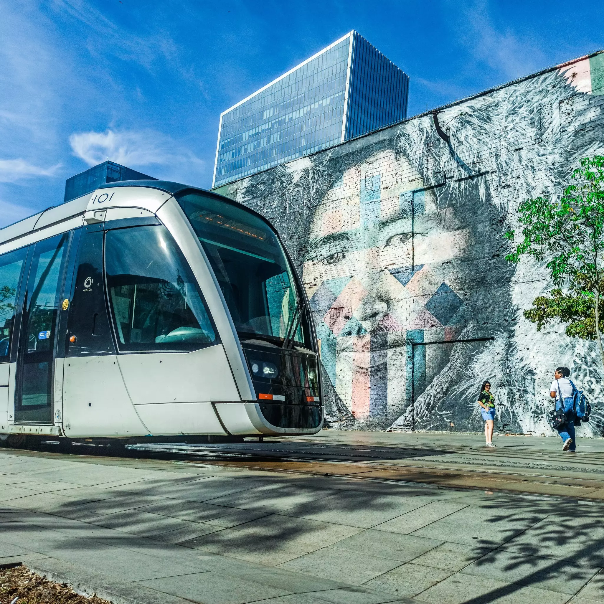 a VLT Rio de Janeiro on Olympic Boulevard passing a muralled wall.