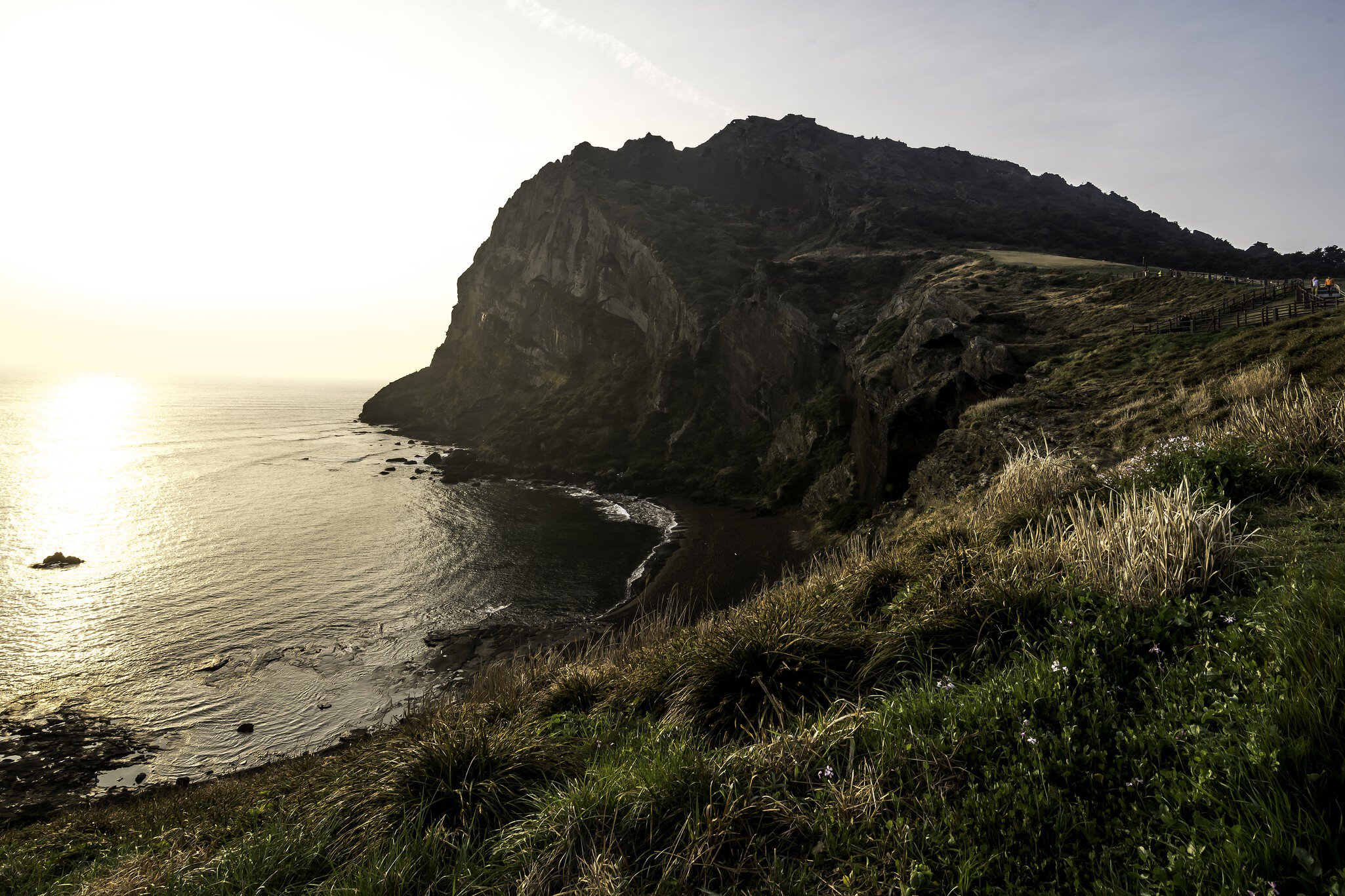 Scenic view of sea and hill at sunrise, Seongsan Ichulbong.