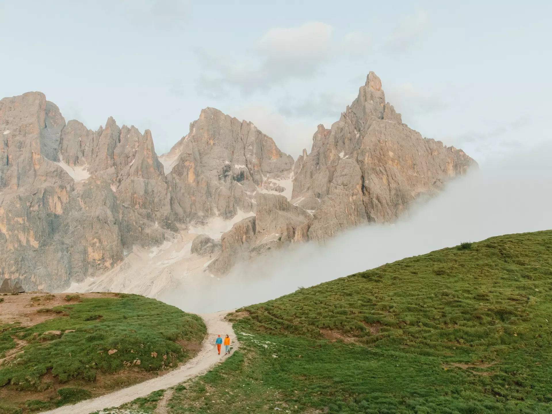 Orla Thomas and guide Narciso Simion walking near Pale di San Martino