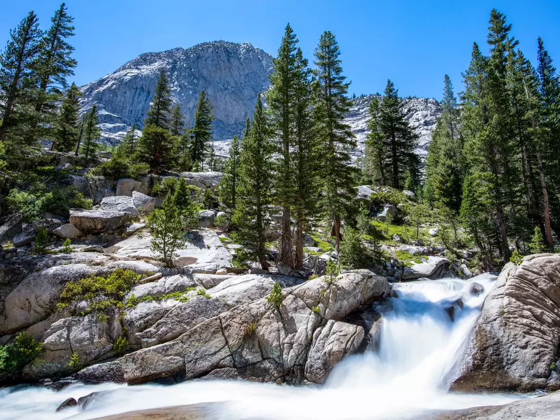 Trailside stream transforms into a gushing waterfall in the John Muir Wilderness, California.