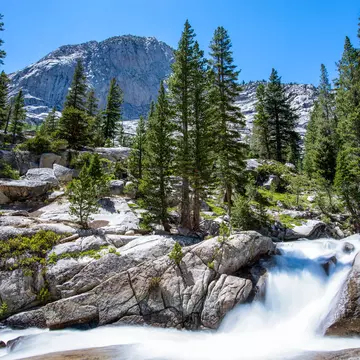 Trailside stream transforms into a gushing waterfall in the John Muir Wilderness, California.