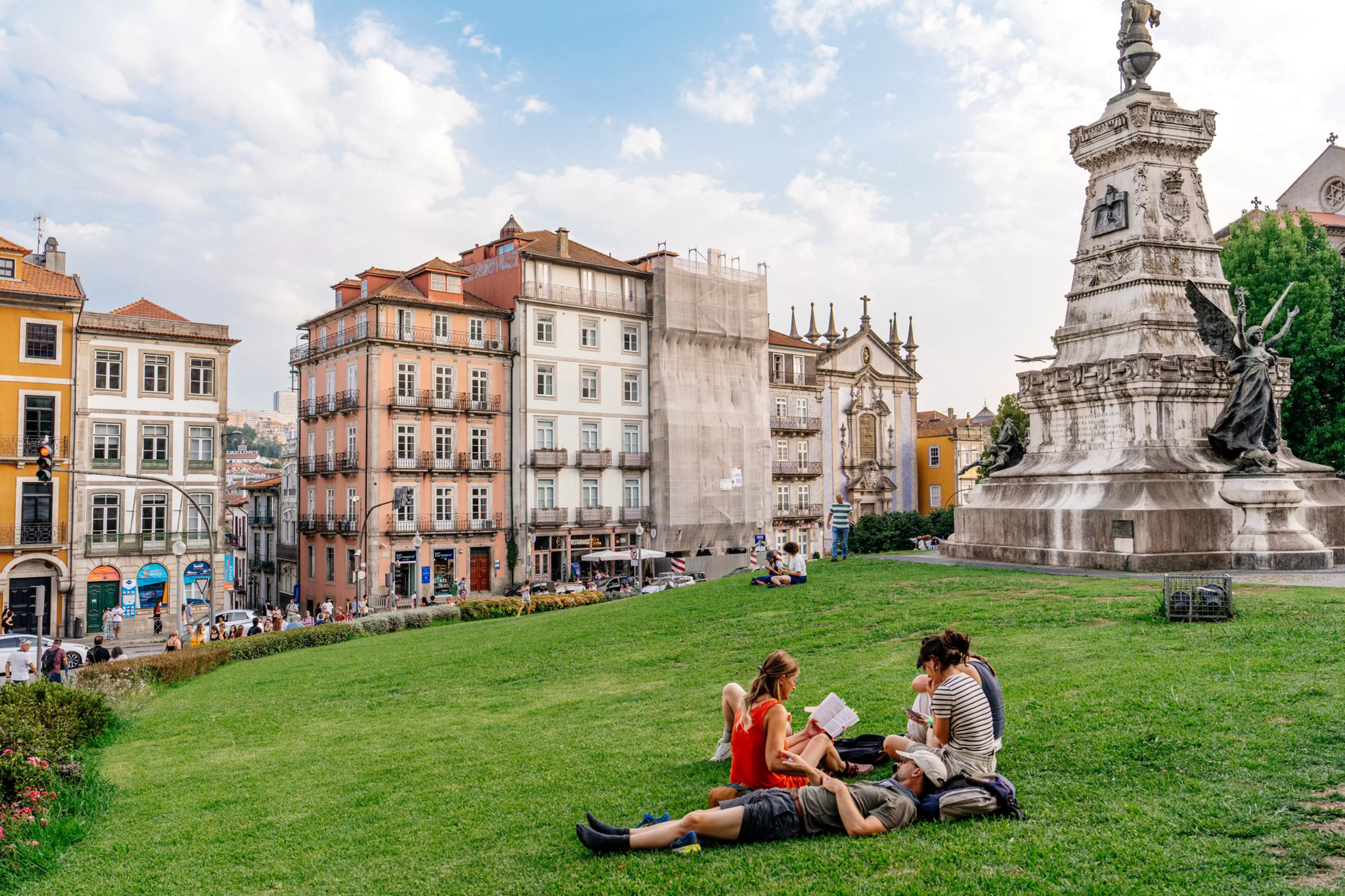 Parkgoers at the Jardim do Infante Dom Henrique, under the statue of Prince Henry The Navigator.