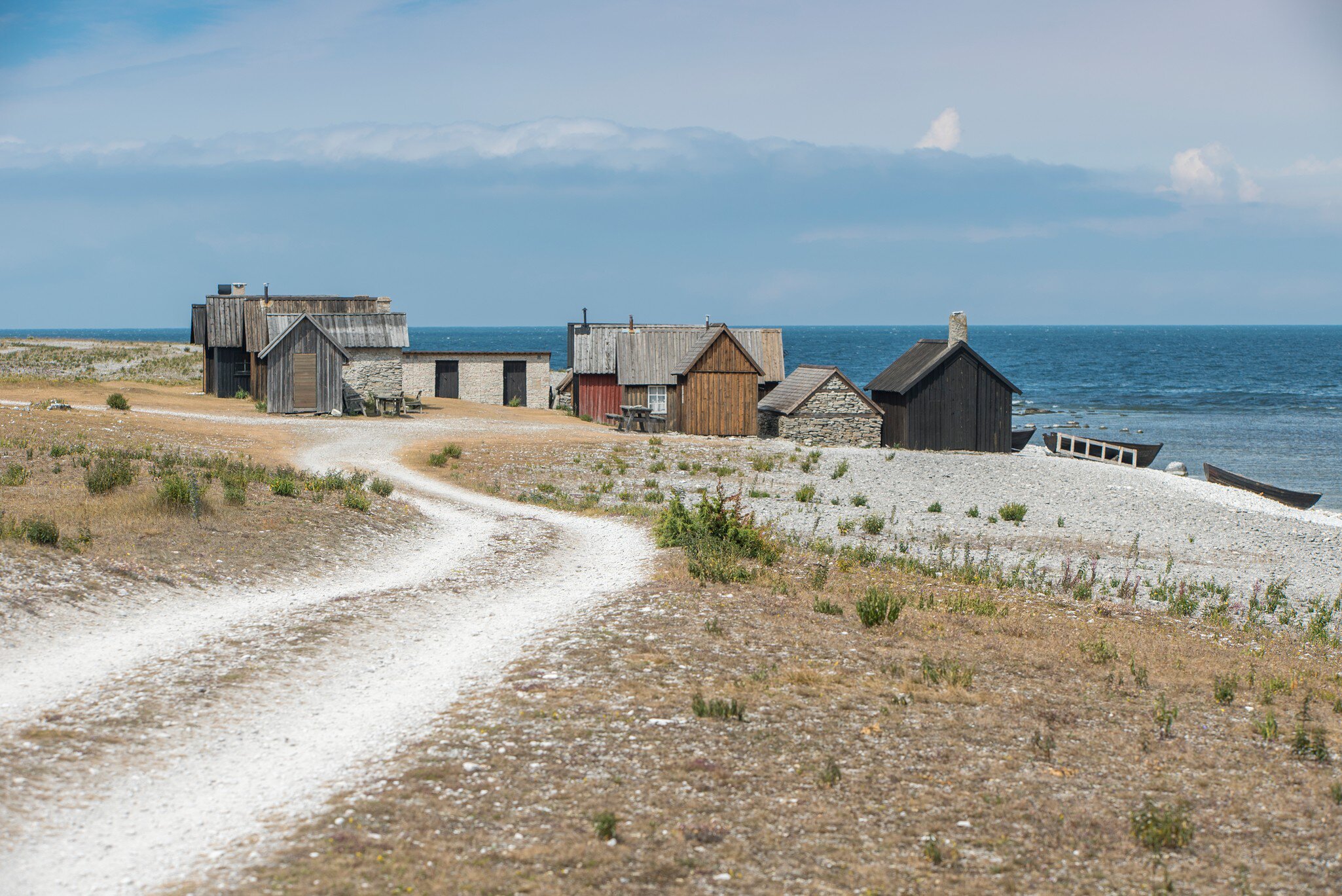 769722457
beach, building, calmness, coast, color image, day, Faro, fishing village, Gotland, gravelled road, horizon, horizon over water, horizontal, house, landscape, no people, outdoors, road, Scandinavia, sea, summer, Sweden, water, winding, wooden house, worn
Helgumannens Fiskeläge Fårö, Sweden
