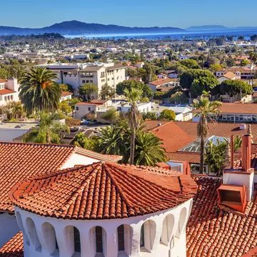 View of Santa Barbara red tile roofs, beach, and mountains