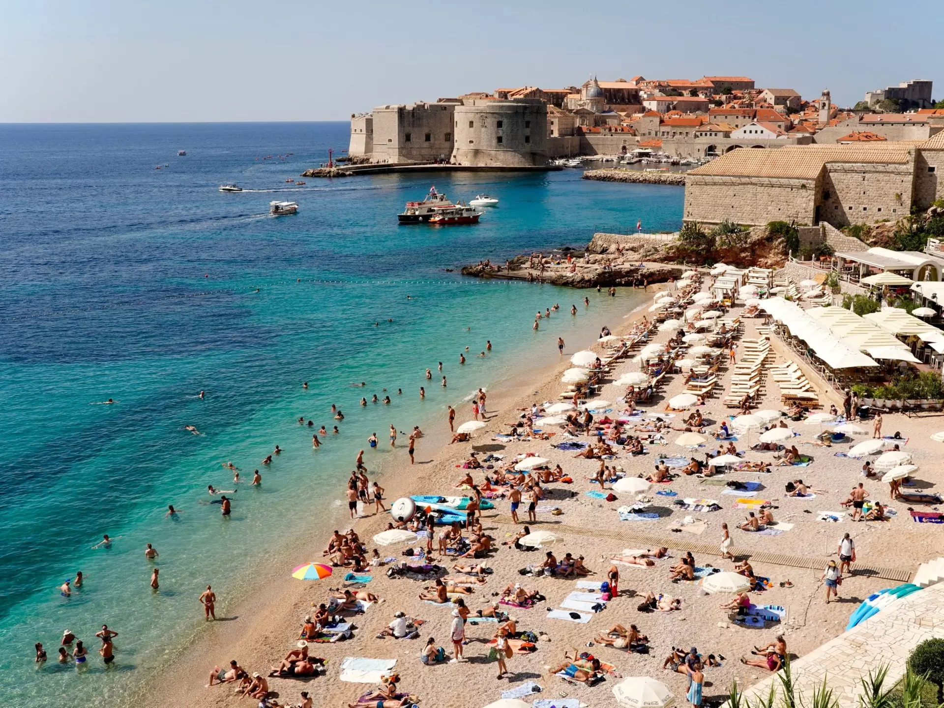 Tourists swiming and sunbathing at Banje Beach, Dubrovknik