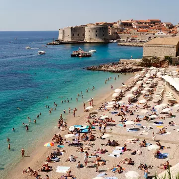 Tourists swiming and sunbathing at Banje Beach, Dubrovknik