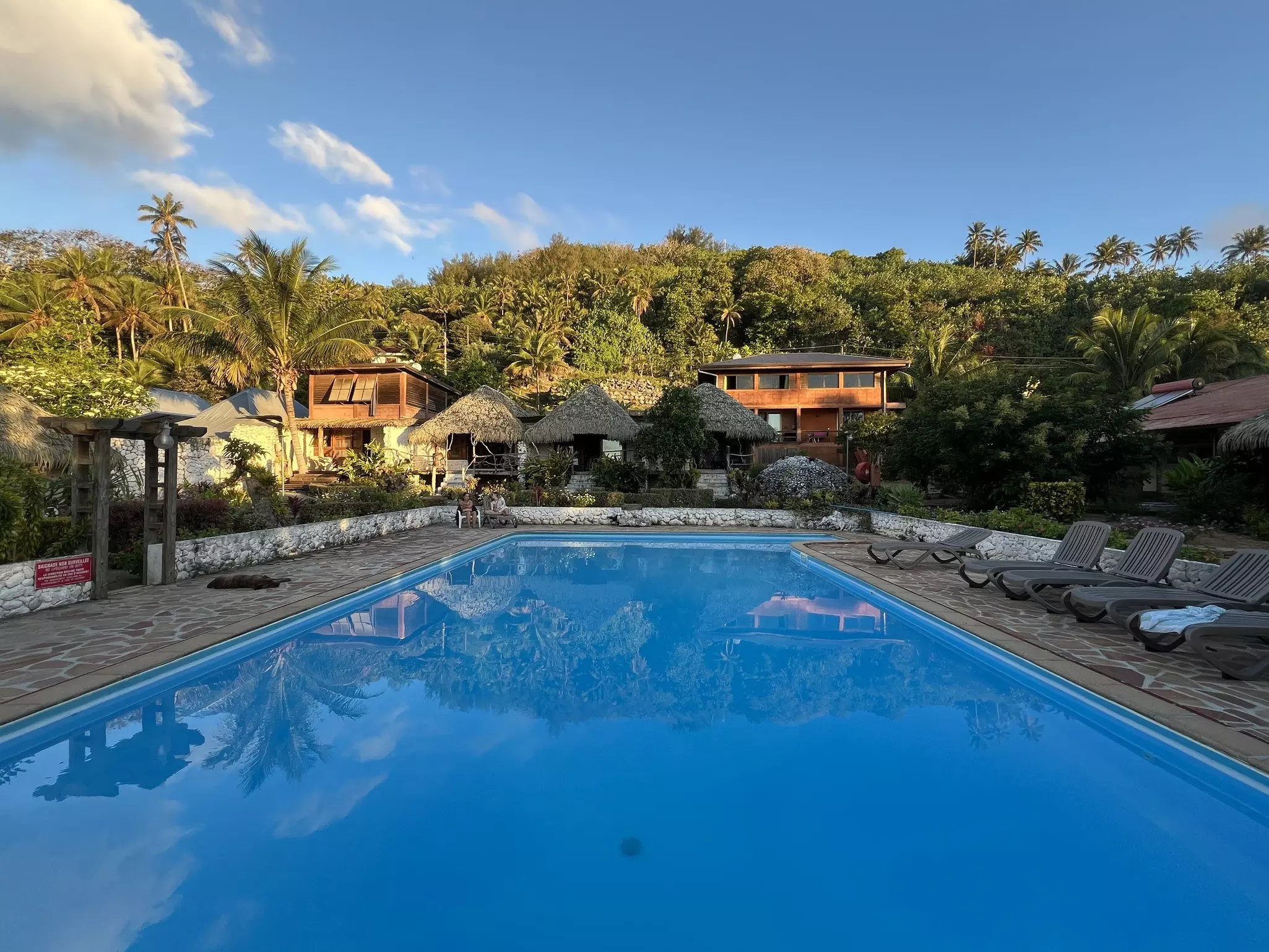 The swimming pool and lounge chairs at Vaitumu Village in Rurutu