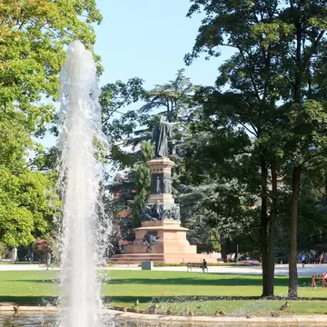 Fountain and monument statue of Dante Alighieri in park Giardini Pubblici in Trento, Italy