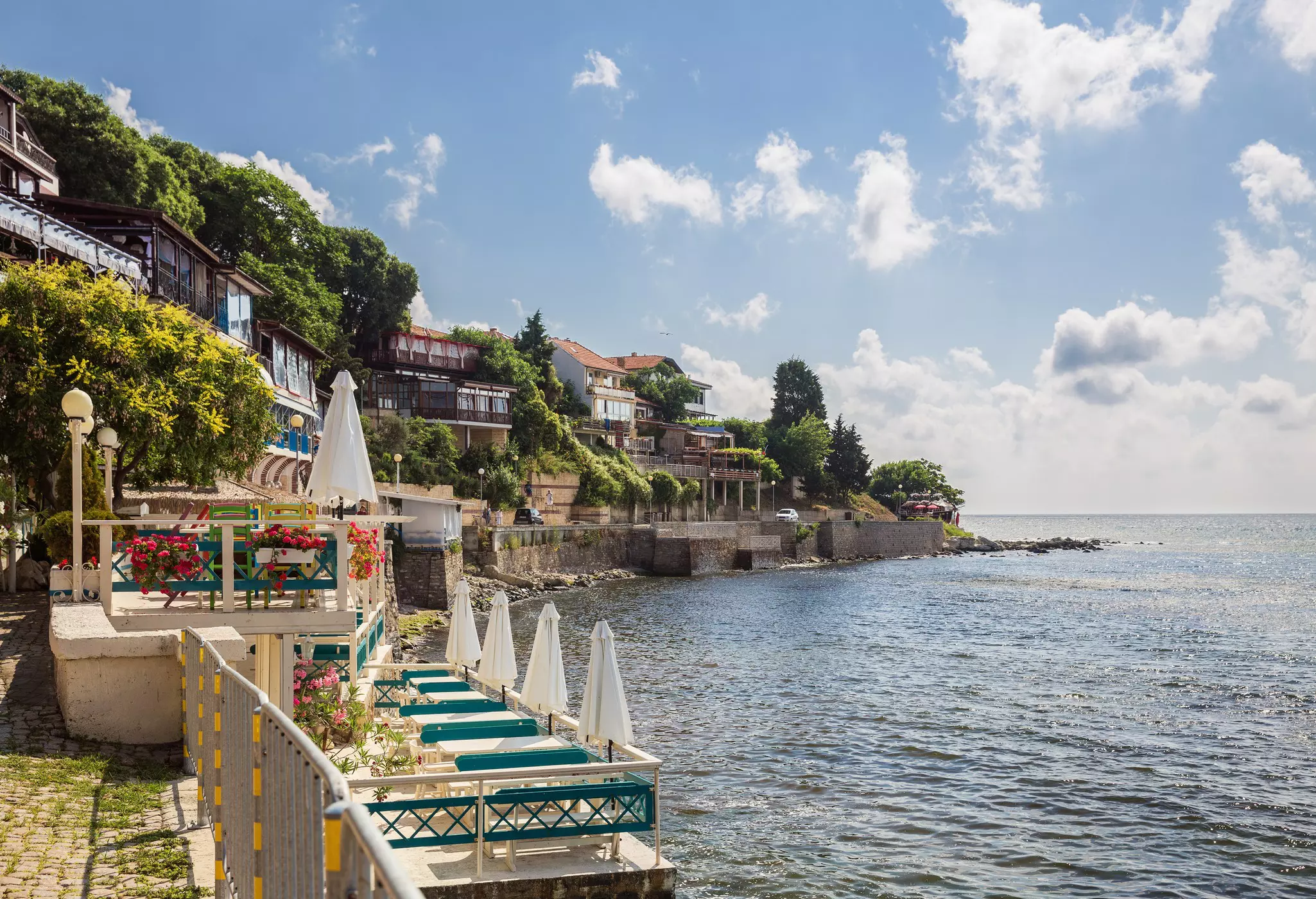 Cafe terraces at the edge of the sea on a sunny day
