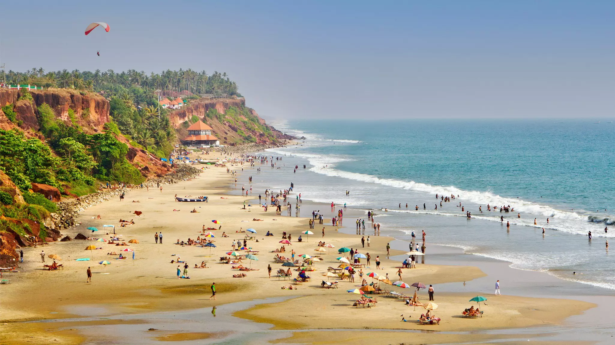 People enjoying the beach at Varkala in Kerala, India.