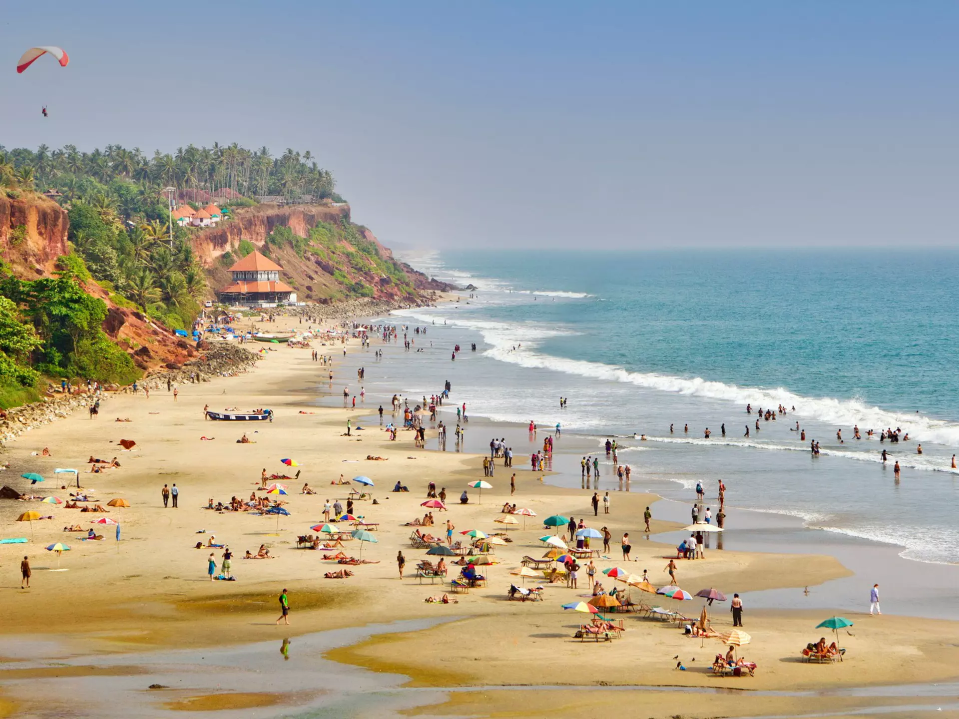 People enjoying the beach at Varkala in Kerala, India.