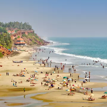 People enjoying the beach at Varkala in Kerala, India.