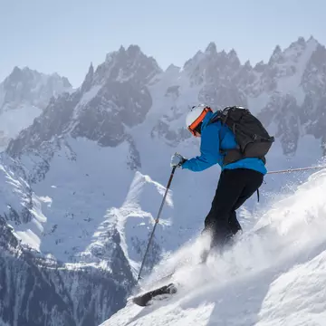 A skier making turns in powder snow in Chamonix, France