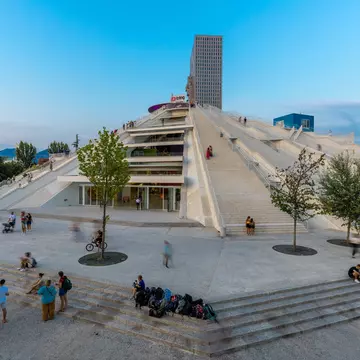 The Pyramid of Tirana at blue hour, locally called the 'Enver Hoxha Mausoleum. Kim Willems / Shutterstock