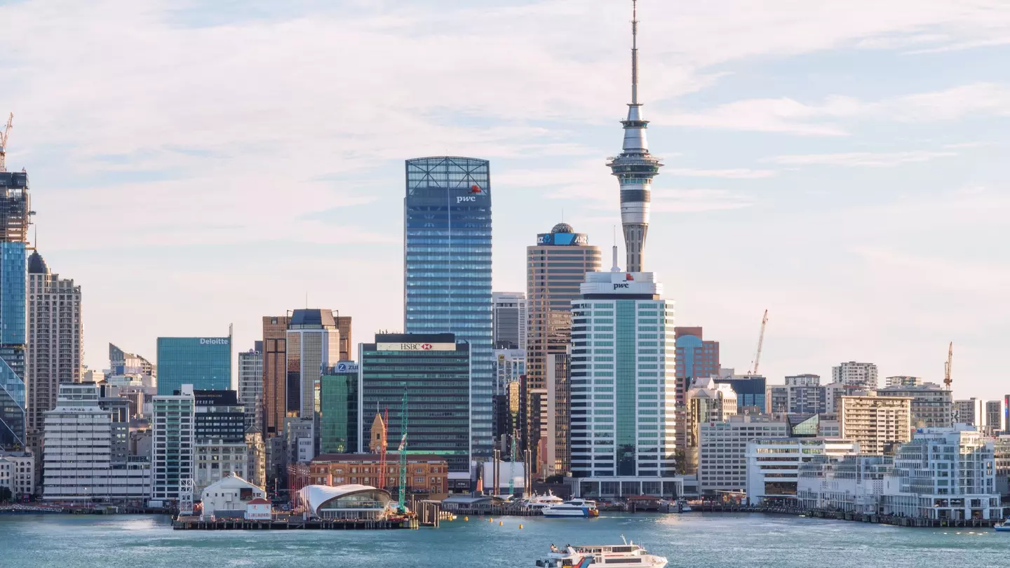 A ferry glide into port amidst the cityscape in Auckland, New Zealand