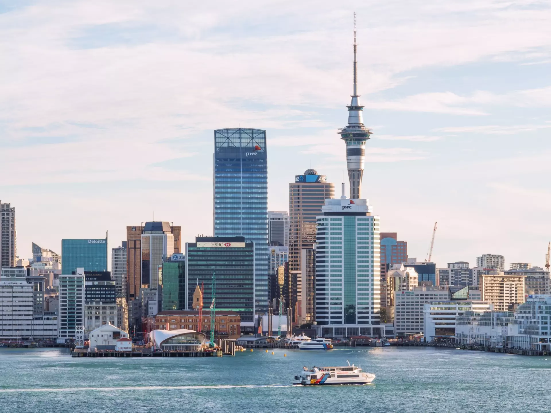 A ferry glide into port amidst the cityscape in Auckland, New Zealand