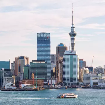 A ferry glide into port amidst the cityscape in Auckland, New Zealand