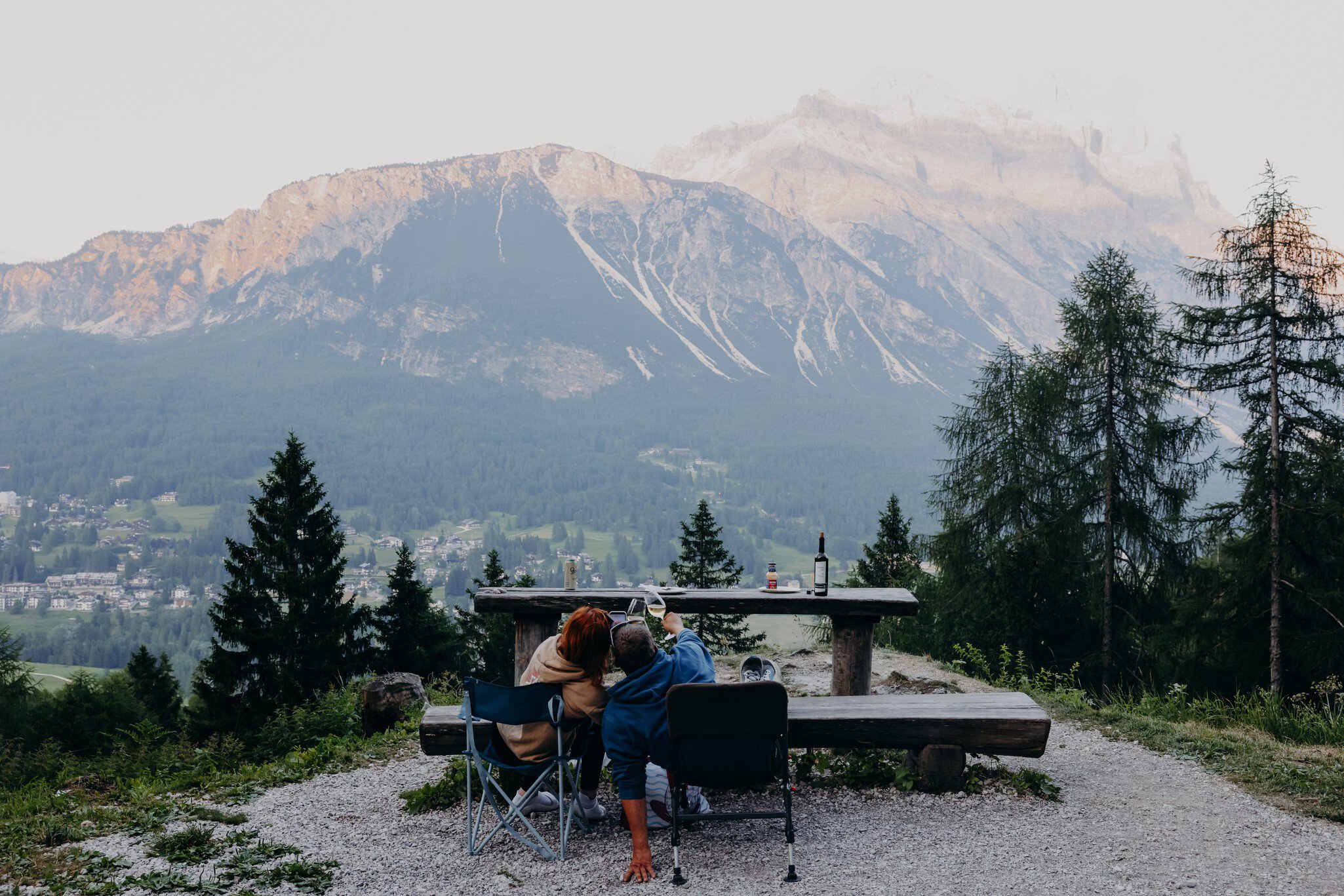 Cortina d'Ampezzo, Italy. June 2025. ..Enjoying the mountain views  while drinking wine and eating grilled meat, with the view of Sorapis and Antelao Mountains. ..Photo by Camilla Ferrari for Lonely Planet