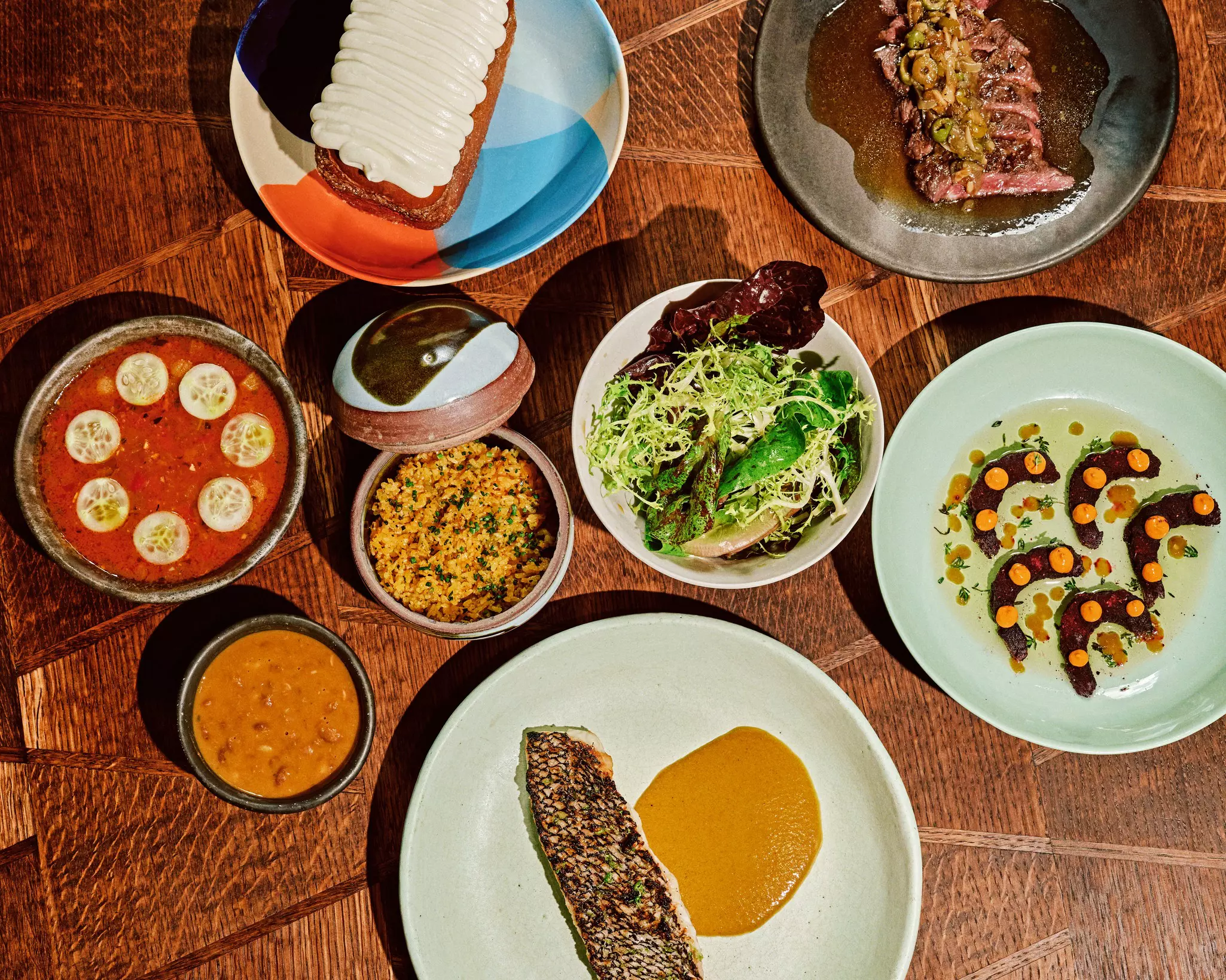 Black bass served with curry, yellow sauce and a side salad with skirt steak, pepper shrimp, cassava dumplings and the coconut turnover at Kawaba in the East Village, New York City. David Cabrera for Lonely Planet