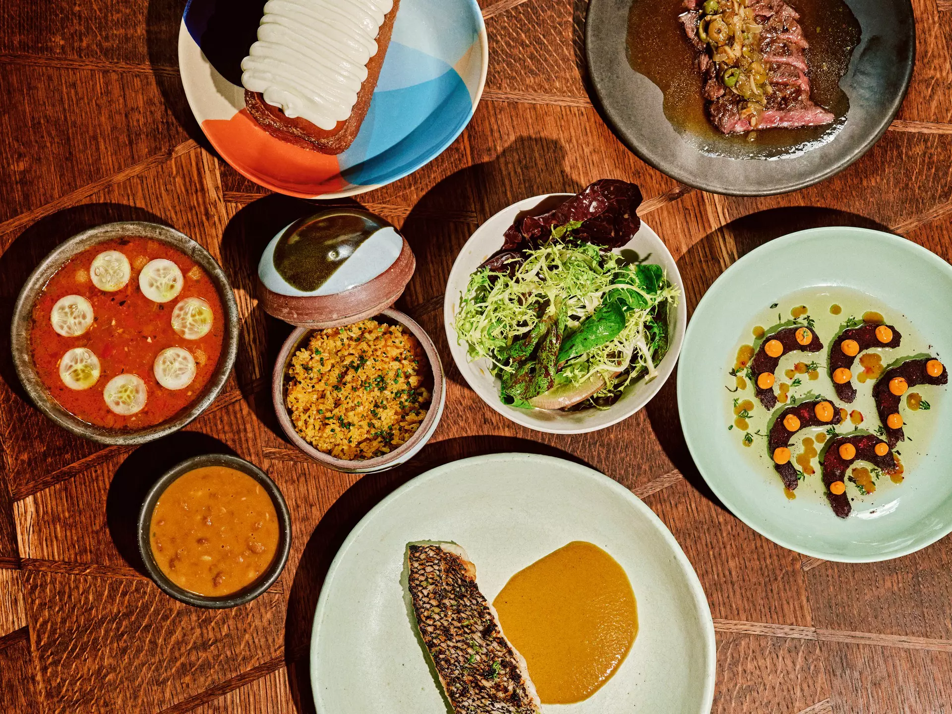 Black bass served with curry, yellow rice, and a side salad, skirt steak, pepper shrimp, cassava dumplings, and the coconut turnover at Kabawa in the East Village, NYC