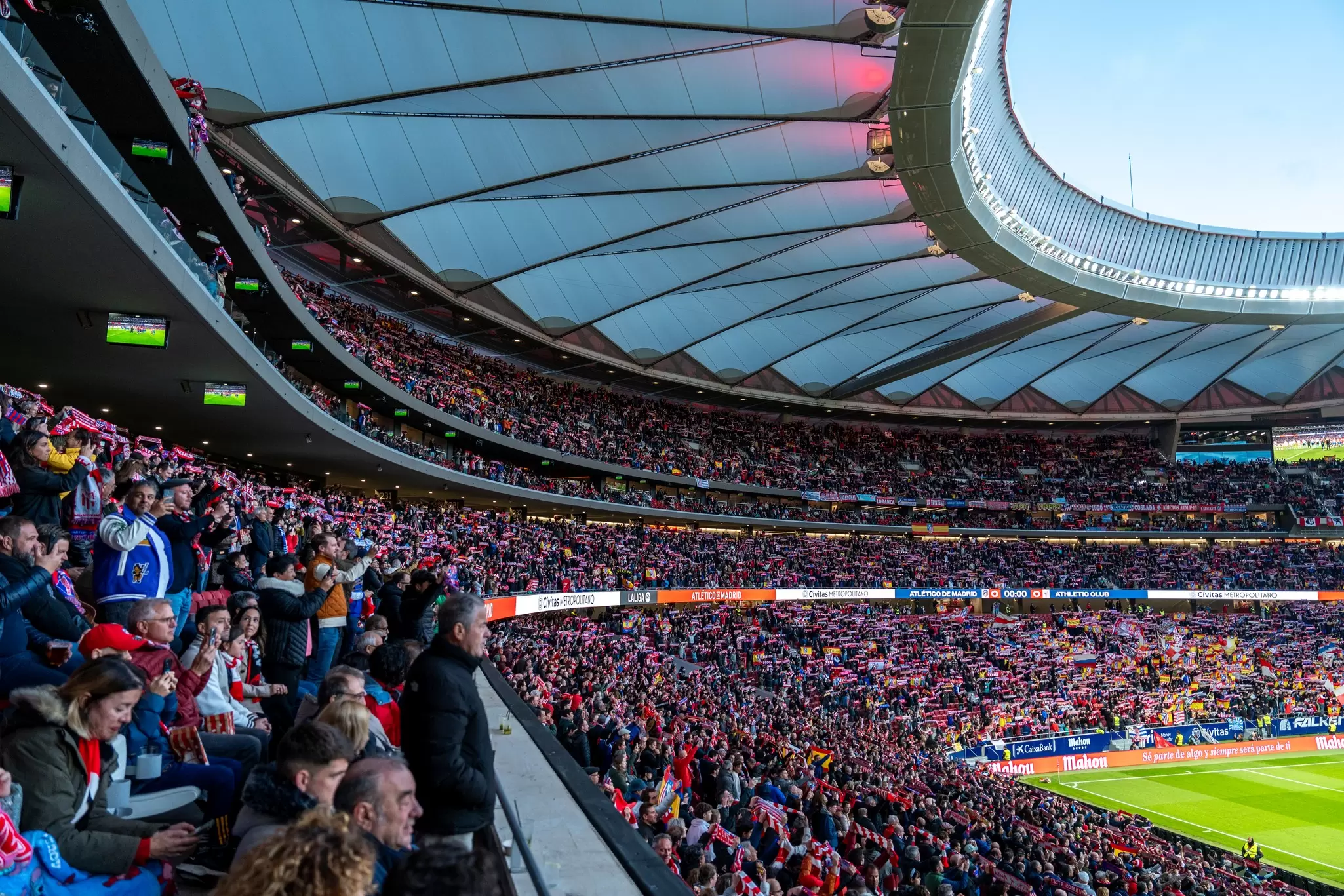 Fans in the stands at a football stadium in Madrid, Spain.