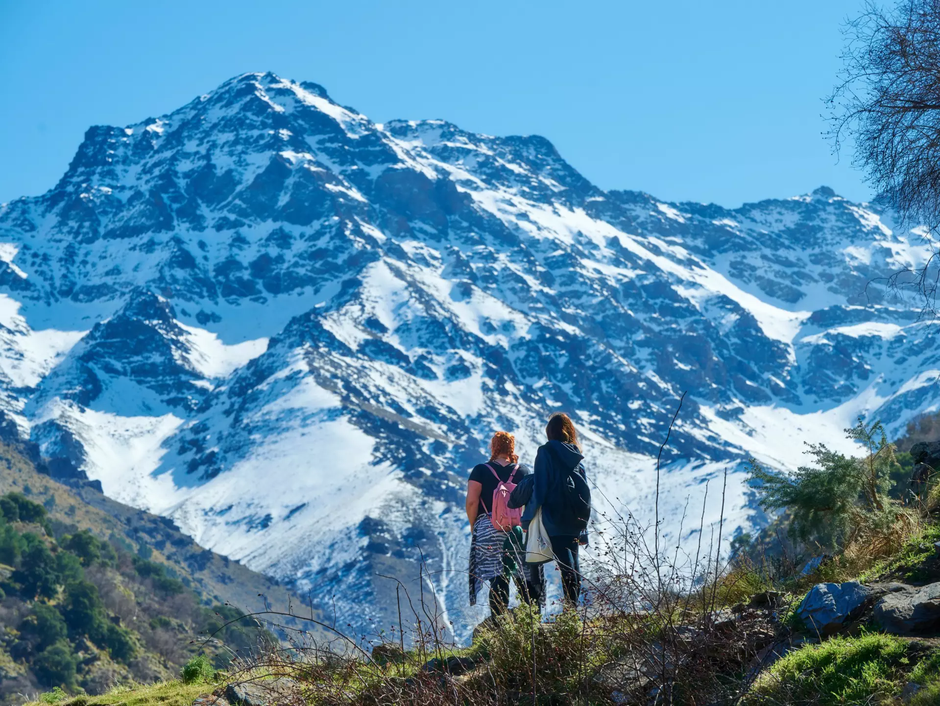 Hikers admire a view of the Sierra Nevada mountains in Andalucía, Spain
