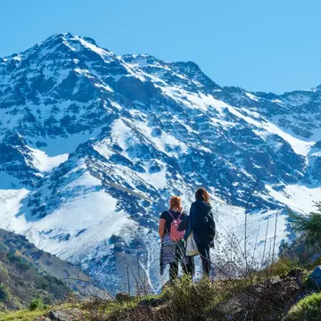 Hikers admire a view of the Sierra Nevada mountains in Andalucía, Spain