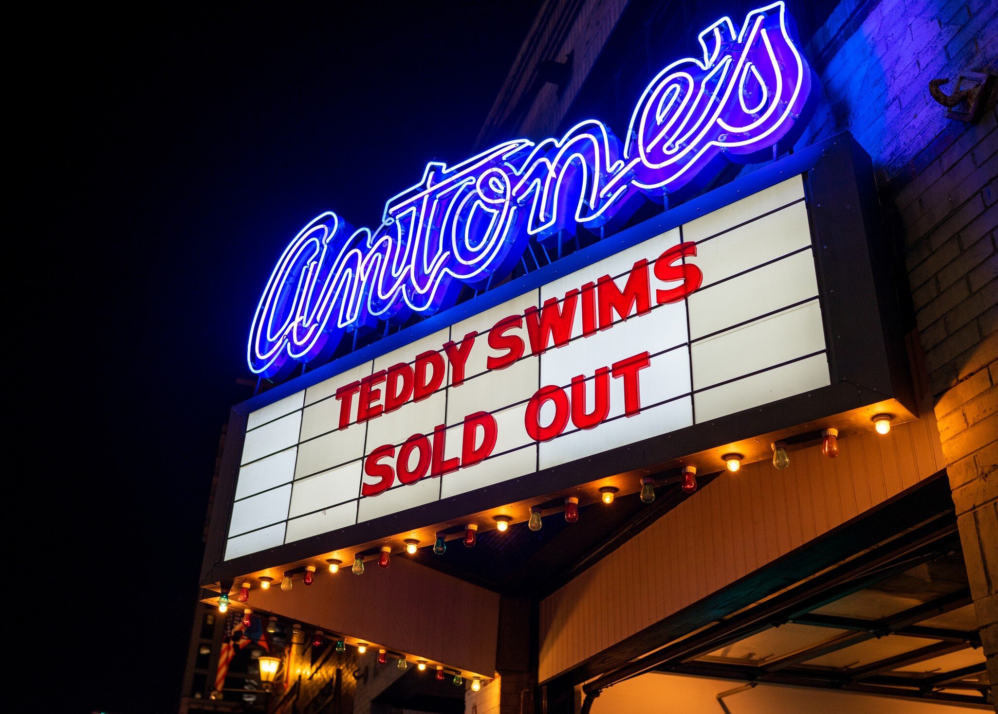 A marquee at night with the name