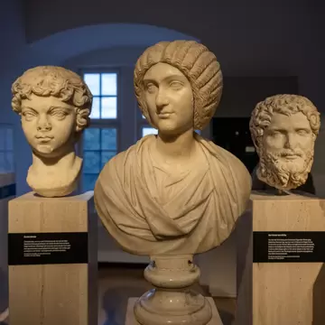 Roman marble relief vessels and lidded container displayed at Landesmuseum Württemberg in Stuttgart, Germany.