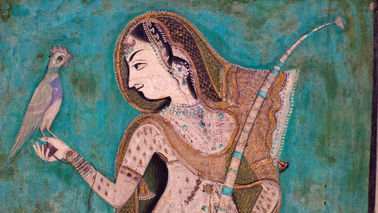 Painting of a woman holding a brid from the 1700's in the Bundi Palace. ©traveler1116/Getty Images