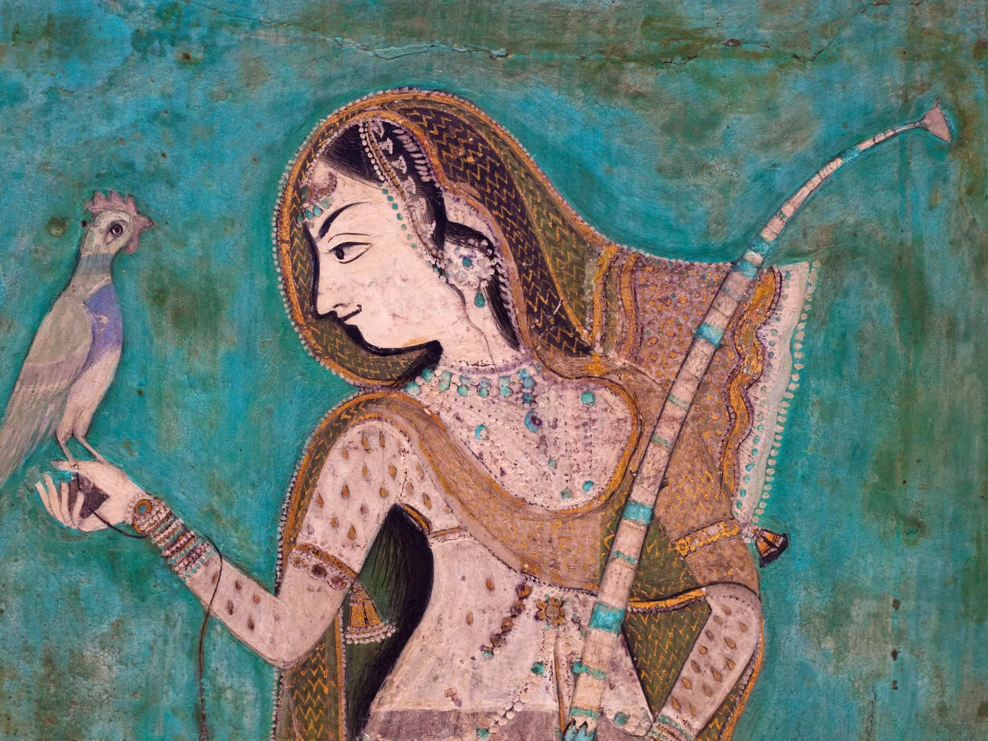 Painting of a woman holding a brid from the 1700's in the Bundi Palace. ©traveler1116/Getty Images
