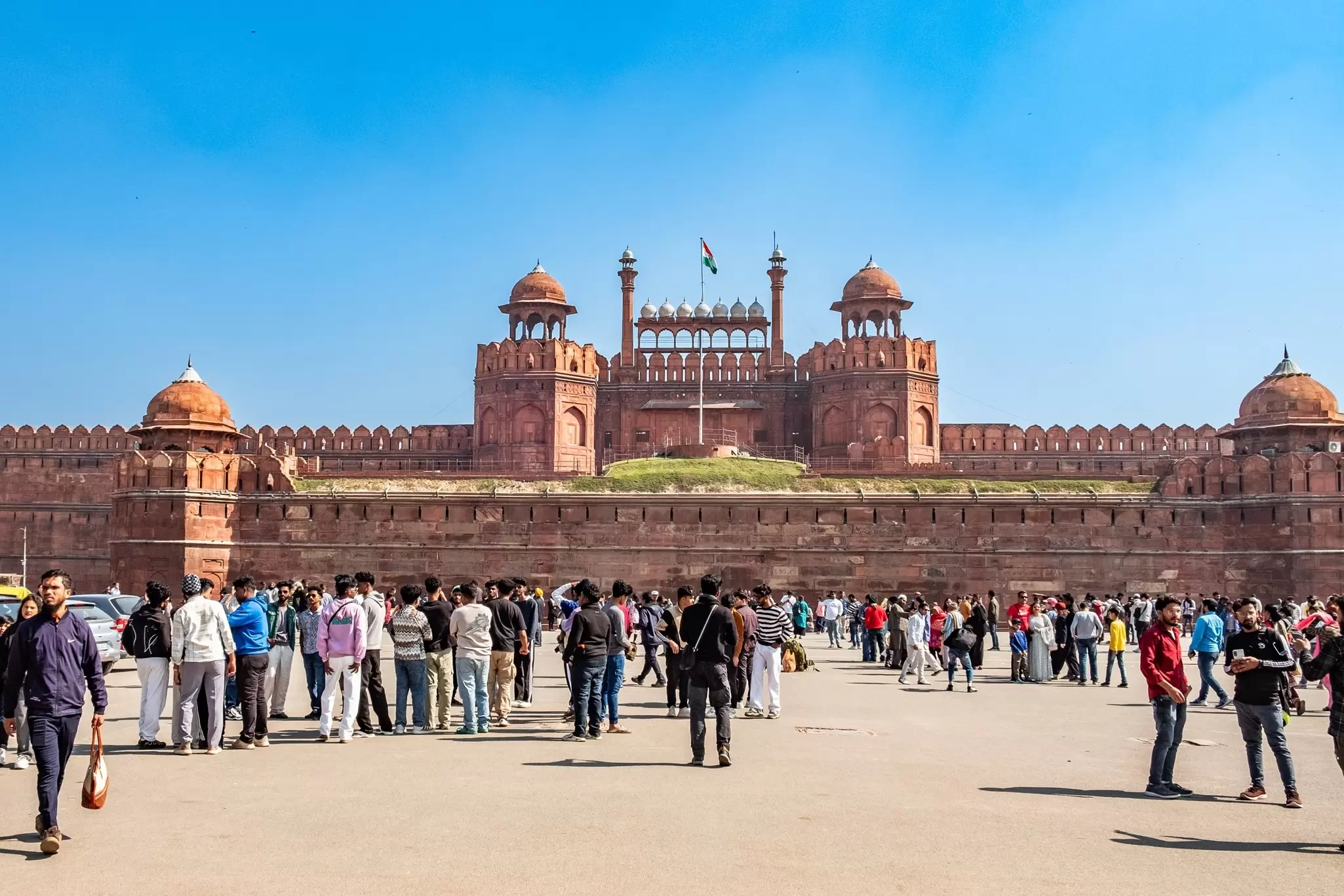 People visit the Red Fort on a sunny day in Delhi, India.