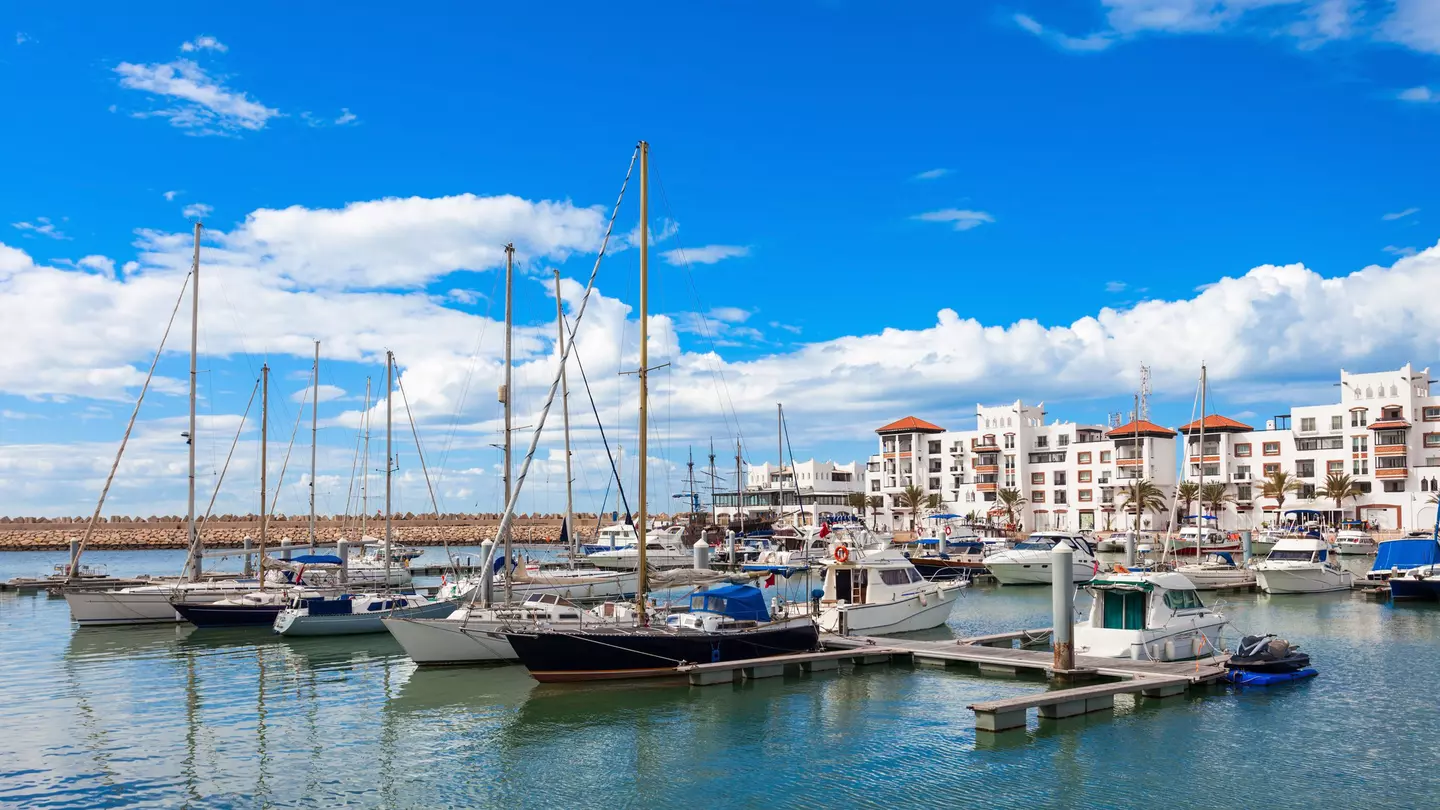 Boats at the marina in Agadir with white buildings in the background