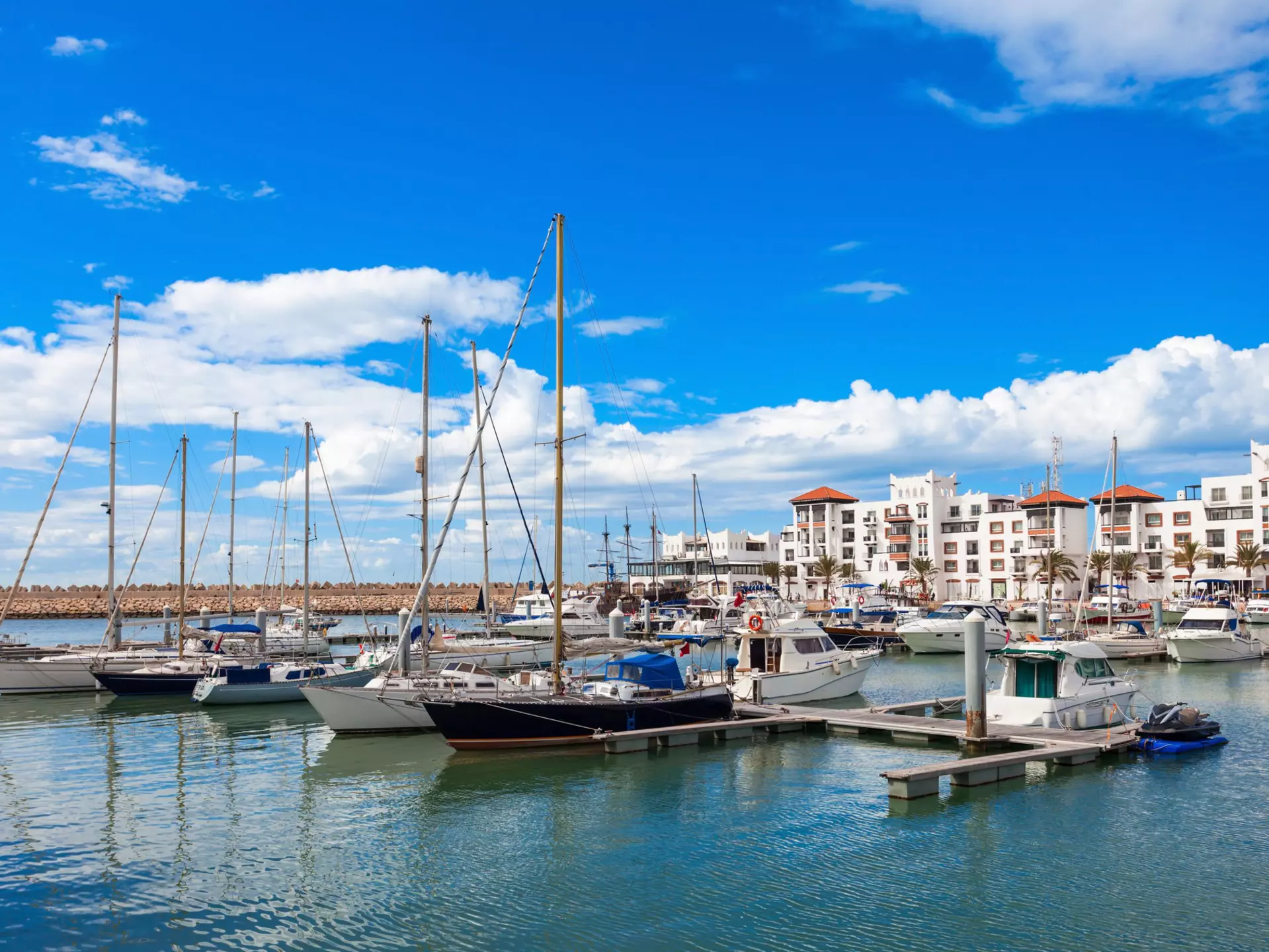 Boats at the marina in Agadir with white buildings in the background