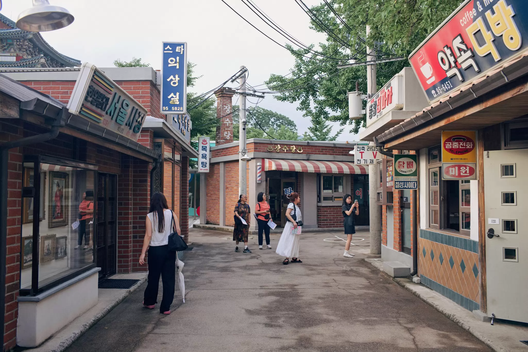 People in a recreated streetscape from 1950s Korea.