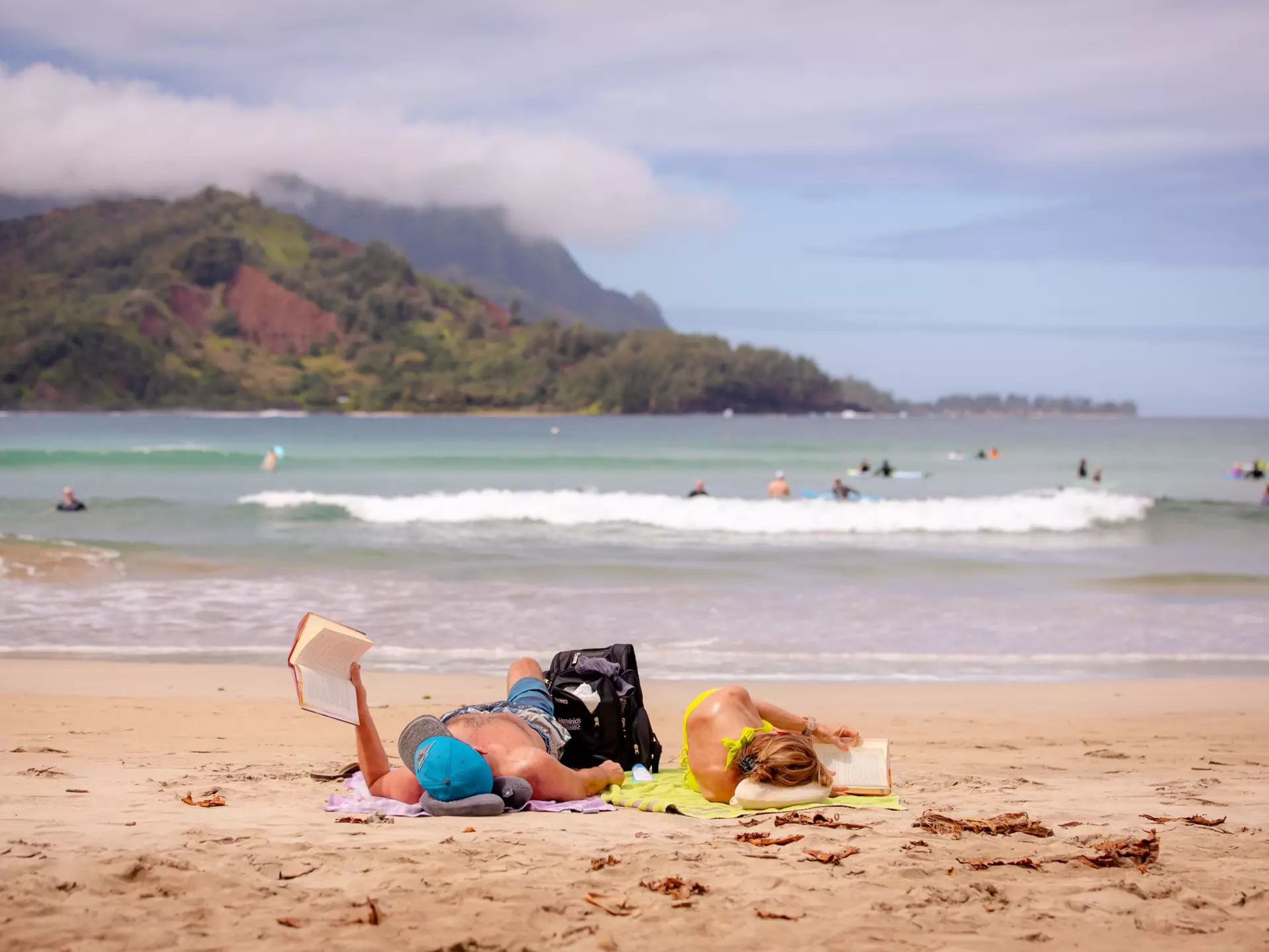Reading on the beach in Hanalei Bay, Kaua'i. bluestork/Shutterstock