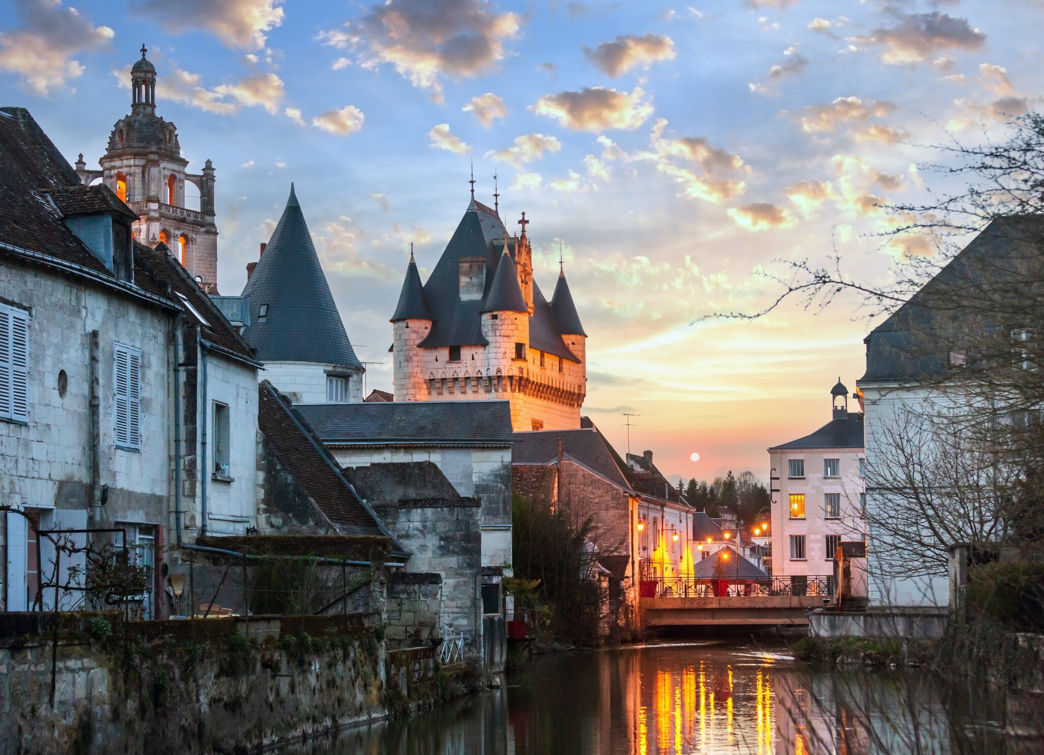 Royal City of Loches spring night view. Loches, Loire Valley, France. Sunset with reflection.