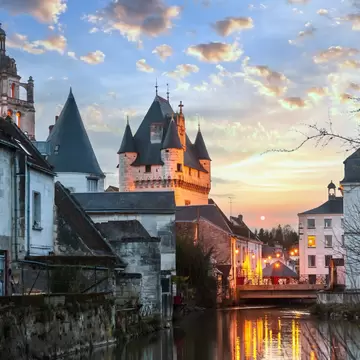 Royal City of Loches spring night view. Loches, Loire Valley, France. Sunset with reflection.