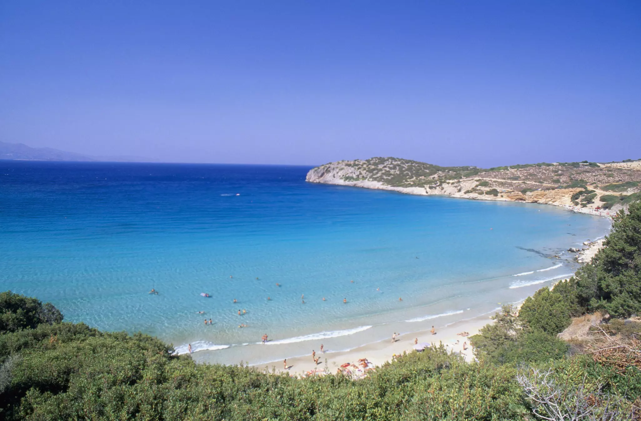 Sunbathers on a sandy beach near the town of Gournia