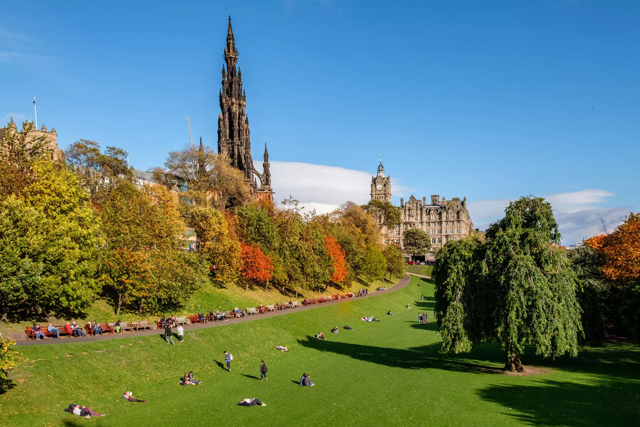 People enjoying the autumn sun in  Edinburgh's famous 'Princess Street Gardens' in mid October.