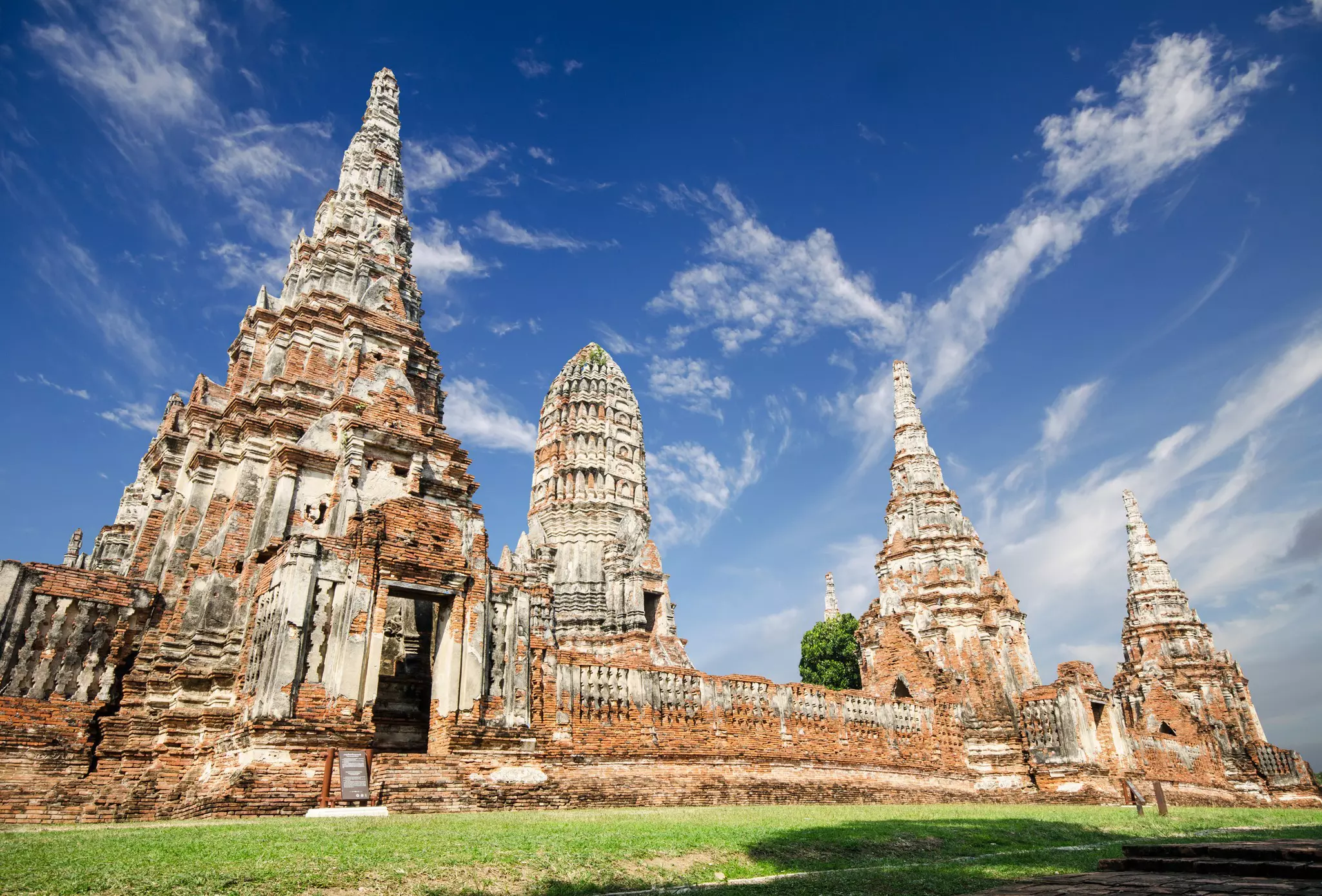 Ruins of a large temple against a blue sky in Ayuthaya, Thailand