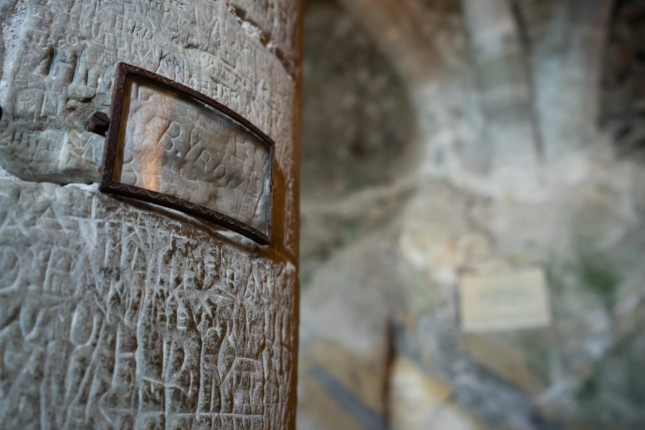 The supposed signature of Lord Byron carved into a wooden beam in the prison of Chillon Castle in Switzerland. The carving has been protected by a plastic screen.