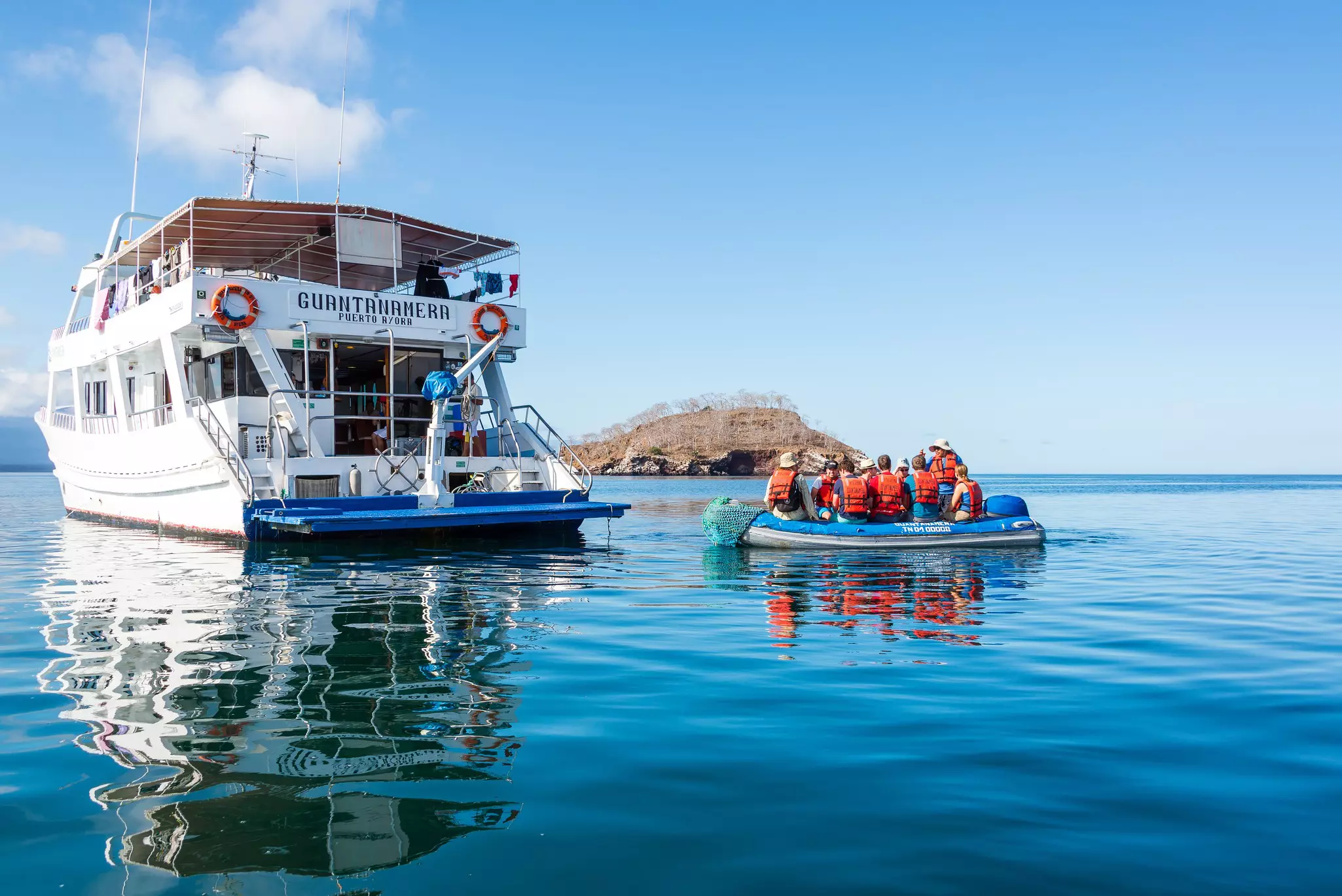 Tourists on a dinghy returning to a cruise ship in the Galapagos Islands, Ecuador