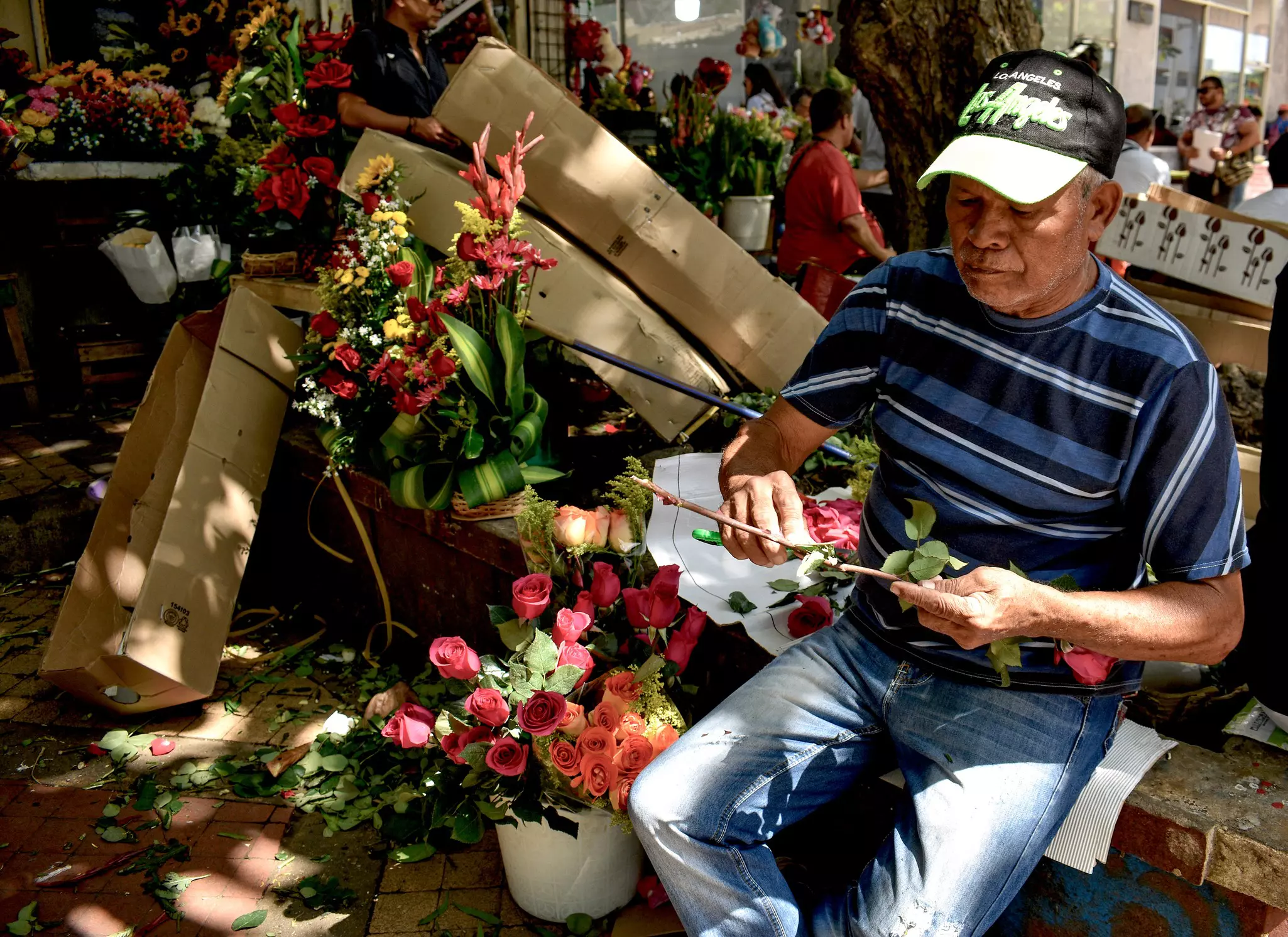 Man preparing floral arrangements for sale in Cartagena, Colombia