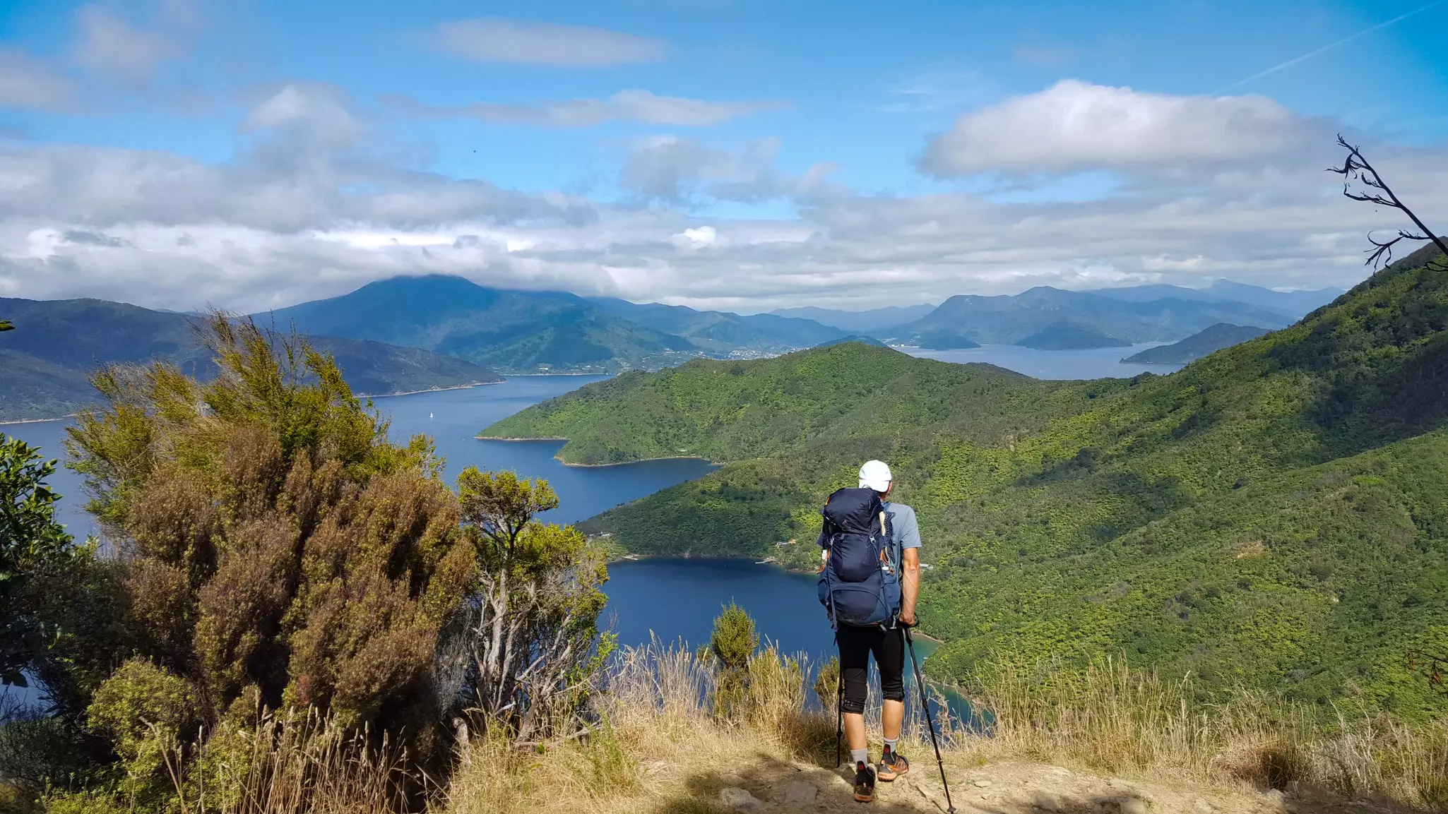 A hiker looking out over a peninsula surrounded by ocean