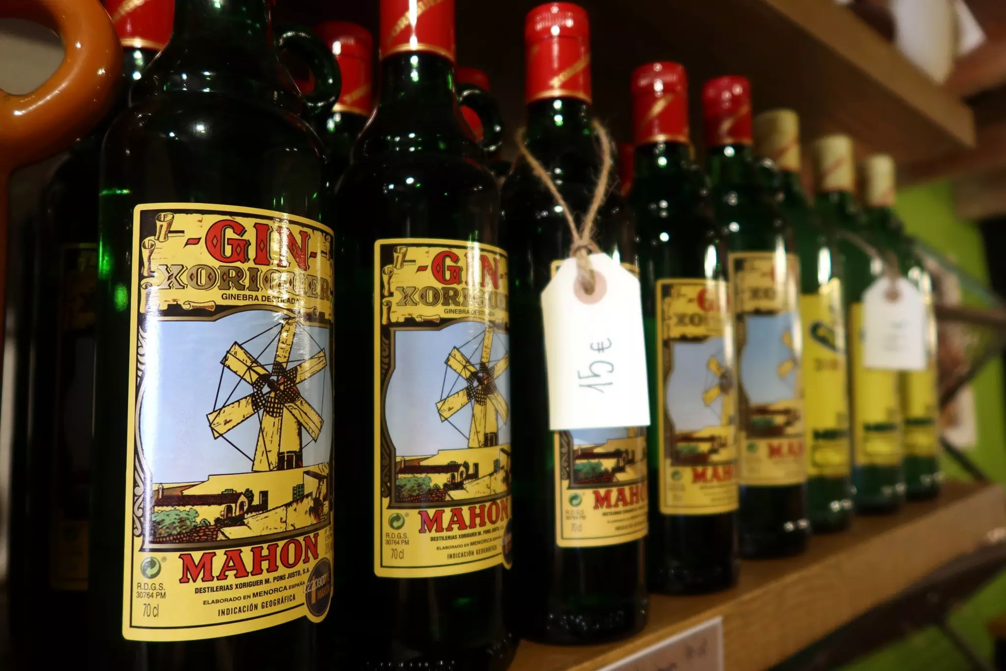 Xoriguer Mahon Gin for sale on the shelf of local shop in Menorca. It has a label with the price.