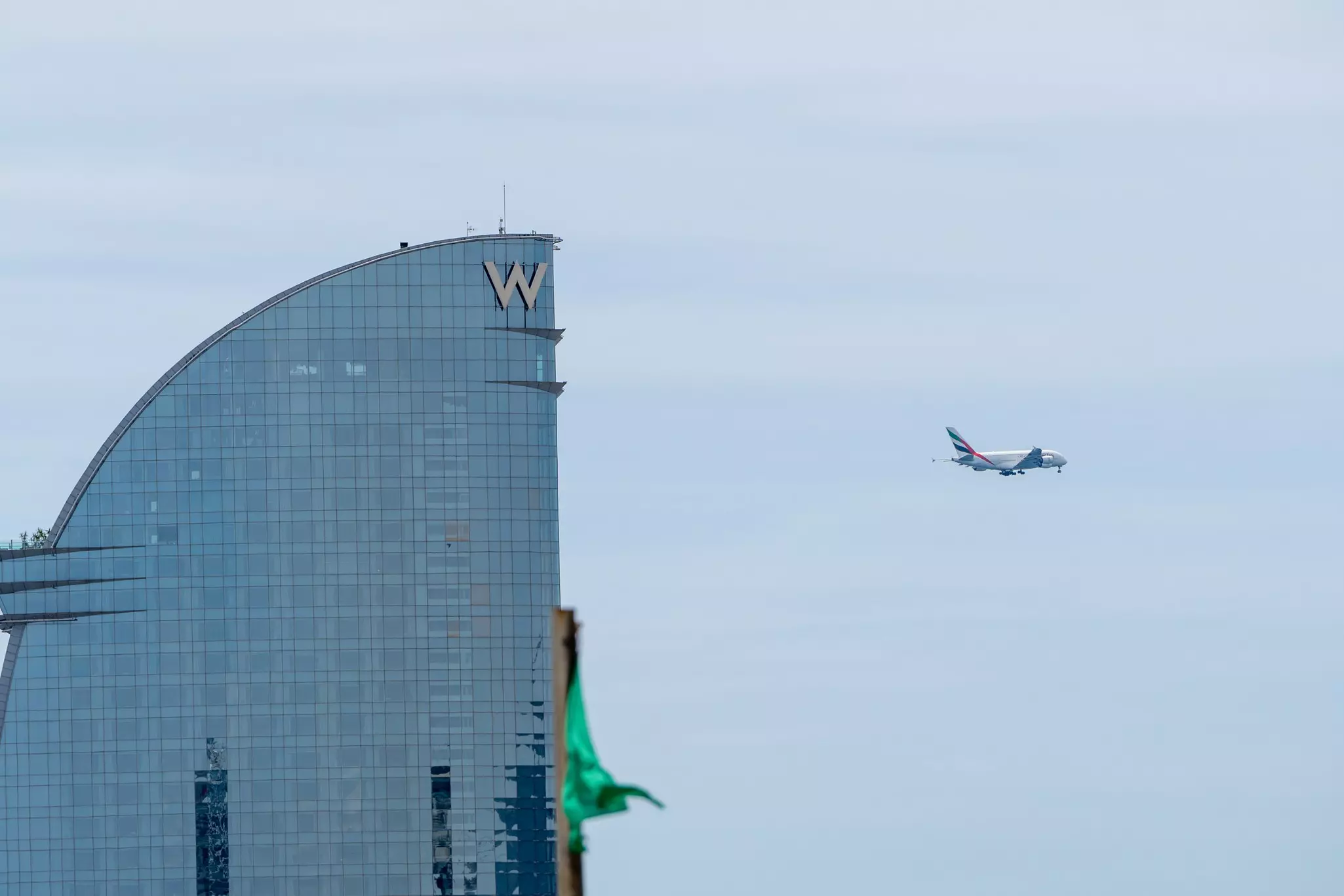 A plane flies over Barcelona.
