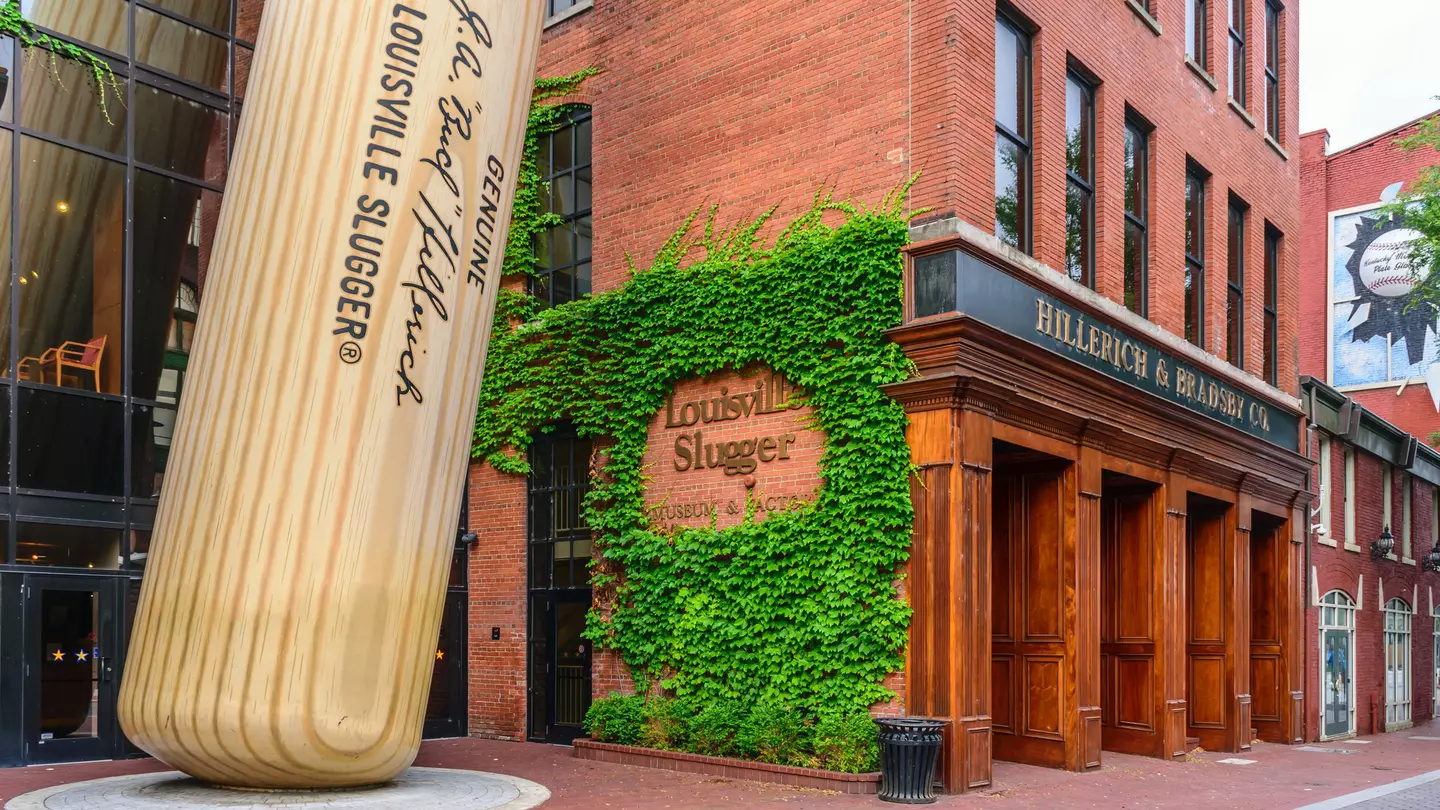 Exterior of the  Louisville Slugger Museum & Factory in downtown Louisville, Kentucky including a giant baseball bat propped up outside